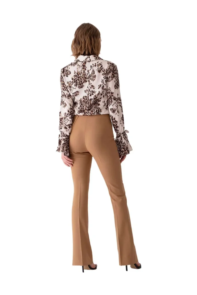 Shop Stelli comfortable camel flare pants, paired with a stylish leopard print blouse, offering a chic and elegant look with a flattering fit.