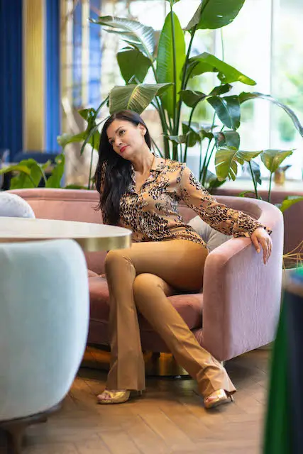 Elegant women's professional attire, featuring a chic leopard print blouse paired with tailored beige trousers, ideal for business meetings, stylish office wear, or upscale events. Perfect for modern professionals seeking a blend of sophistication and comfort, enhancing your wardrobe with versatile and fashionable pieces.