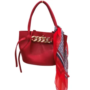 Chic red leather handbag with gold chain details, accessorized with a colorful red and navy scarf, perfect for adding elegance and style to any outfit.