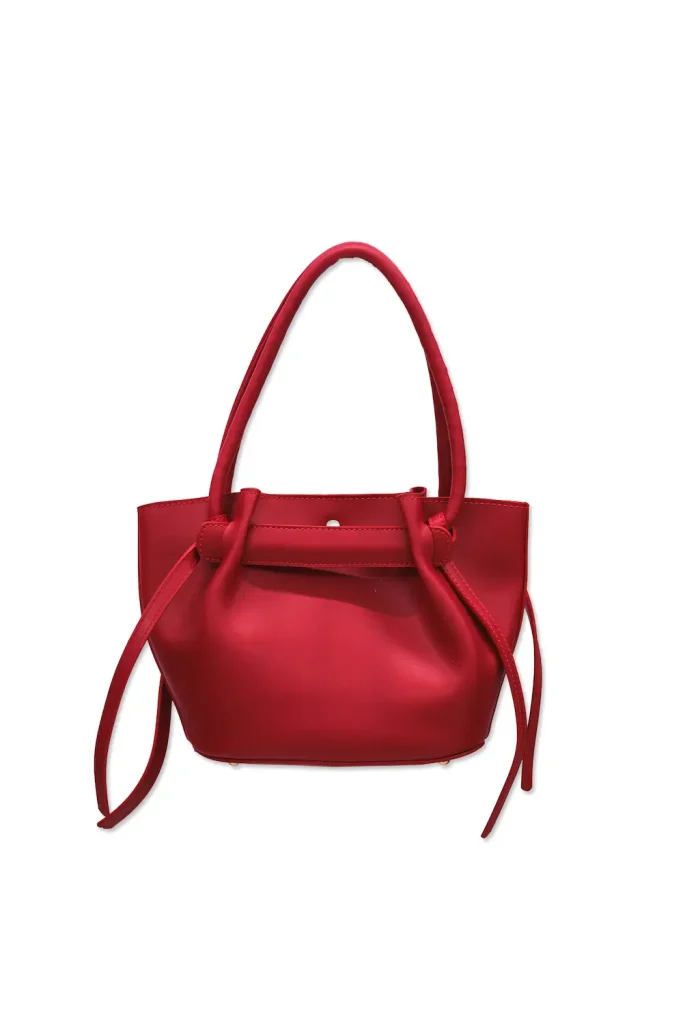 Red leather handbag with gold accents, styled with a chic navy and white patterned scarf for a sophisticated look