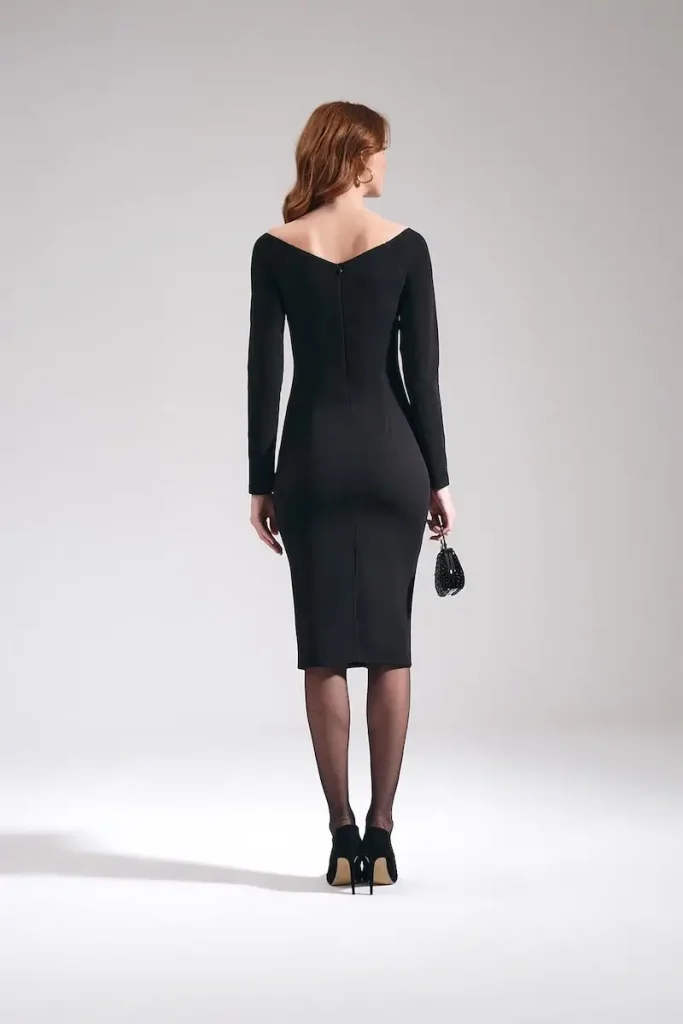 Model wearing MOTRATi black fitted dress under the knee length and sweetheart neckline perfect for any occasion.