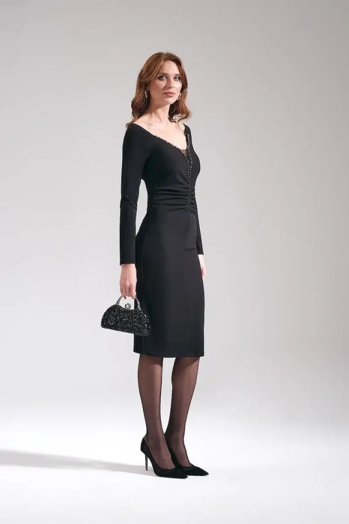 Model wearing MOTRATi black fitted dress under the knee length and sweetheart neckline perfect for any occasion.