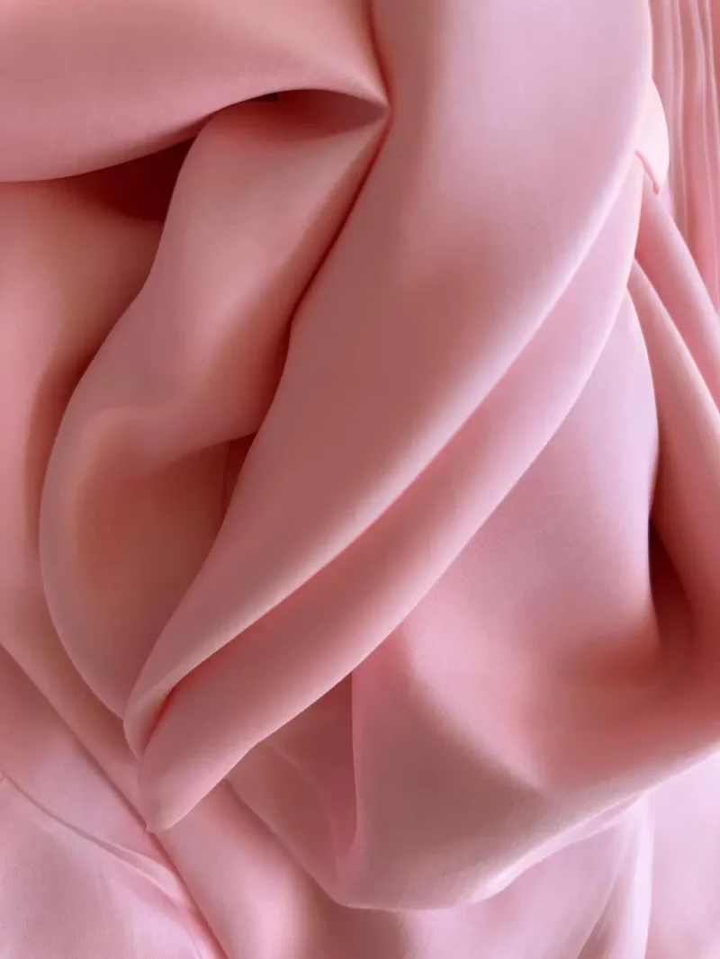 Folded Barbie pink Italian Silk Satin fabric with a bright sheen, ideal for custom garments