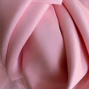Draped Silk Fabric pink in Mulberry Silk Satin showing fluid movement and radiant gloss, perfect for vibrant fashion pieces