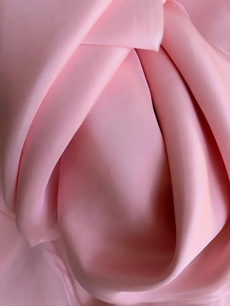Draped Silk Fabric pink in Mulberry Silk Satin showing fluid movement and radiant gloss, perfect for vibrant fashion pieces