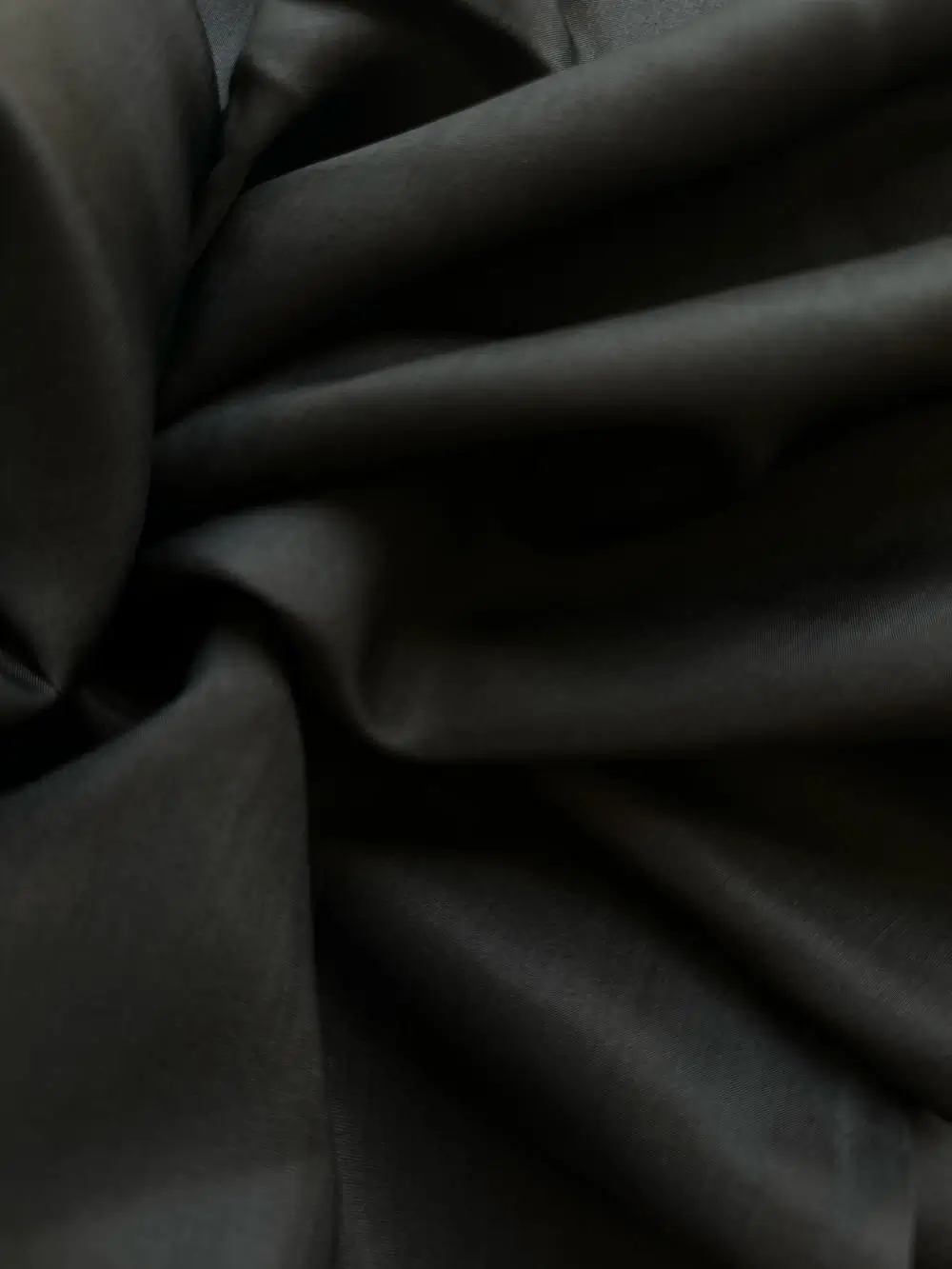Silk Fabric Black Mulberry Silk Satin fabric draped to reveal fluidity and shine, perfect for luxury fashion pieces