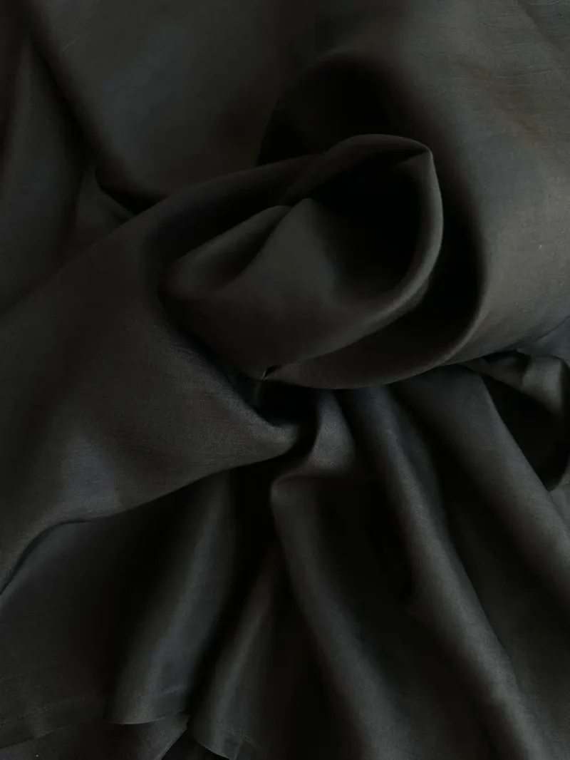 Rolled black Italian Silk Satin with high gloss finish, suitable for shirts, skirts, or dresses