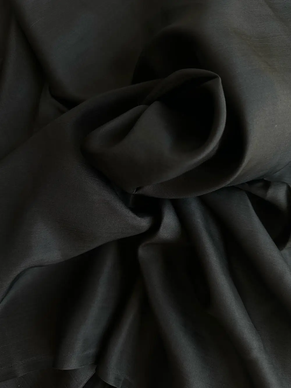 Rolled black Italian Silk Satin with high gloss finish, suitable for shirts, skirts, or dresses