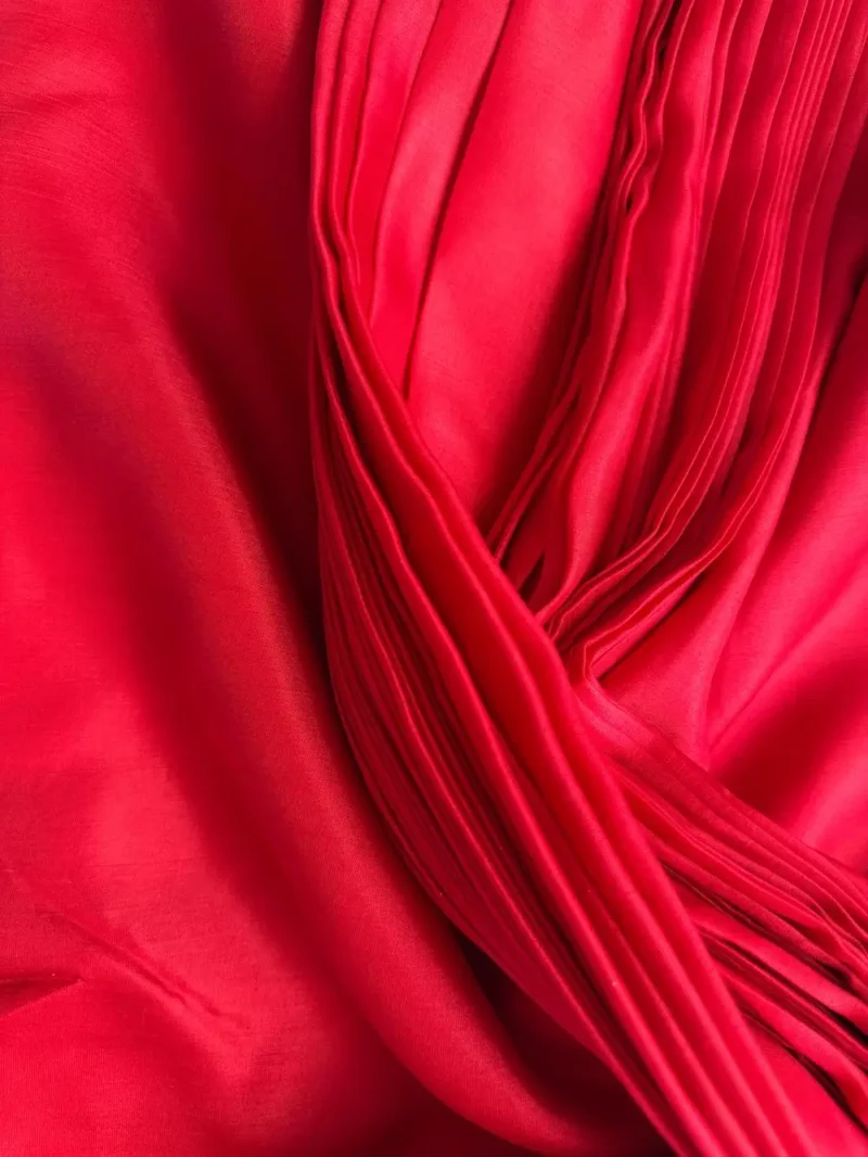 Close-up of ilk Fabric Red - Italian Mulberry Silk Satin with smooth glossy texture, ideal for dressmaking and tailored garments