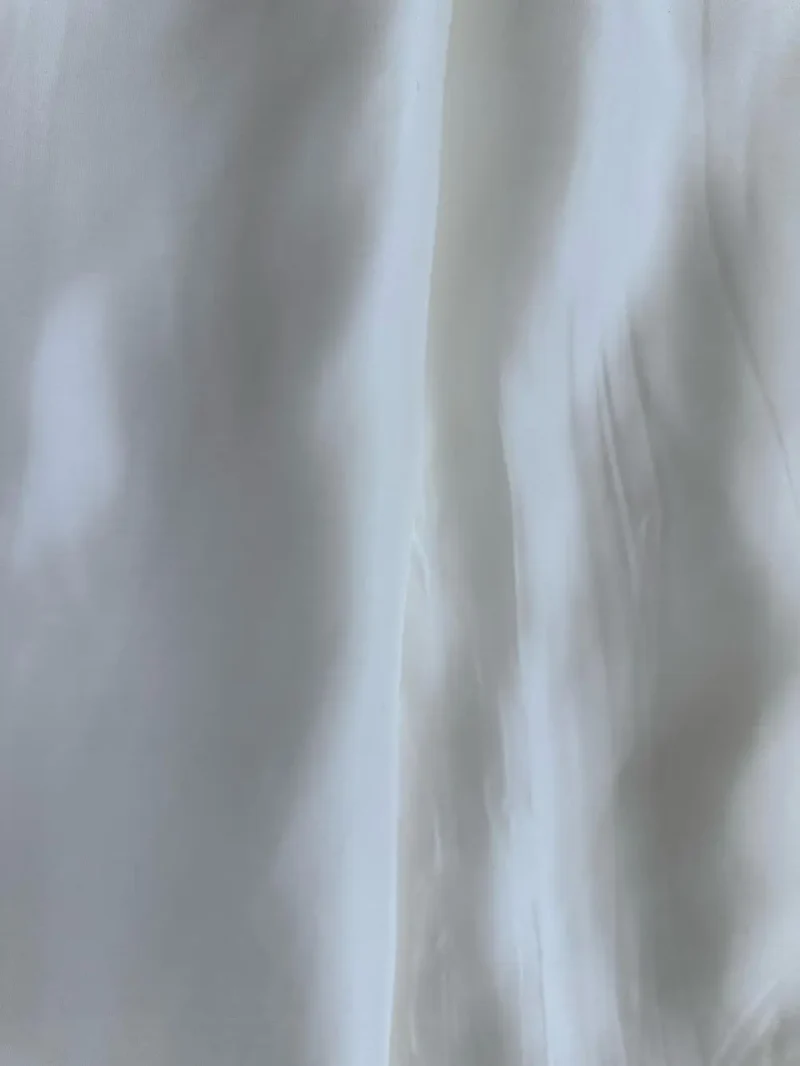 Rolled off-white Italian Silk Satin fabric, luxurious and ready for bespoke fashion pieces like shirts or skirts, dresses.