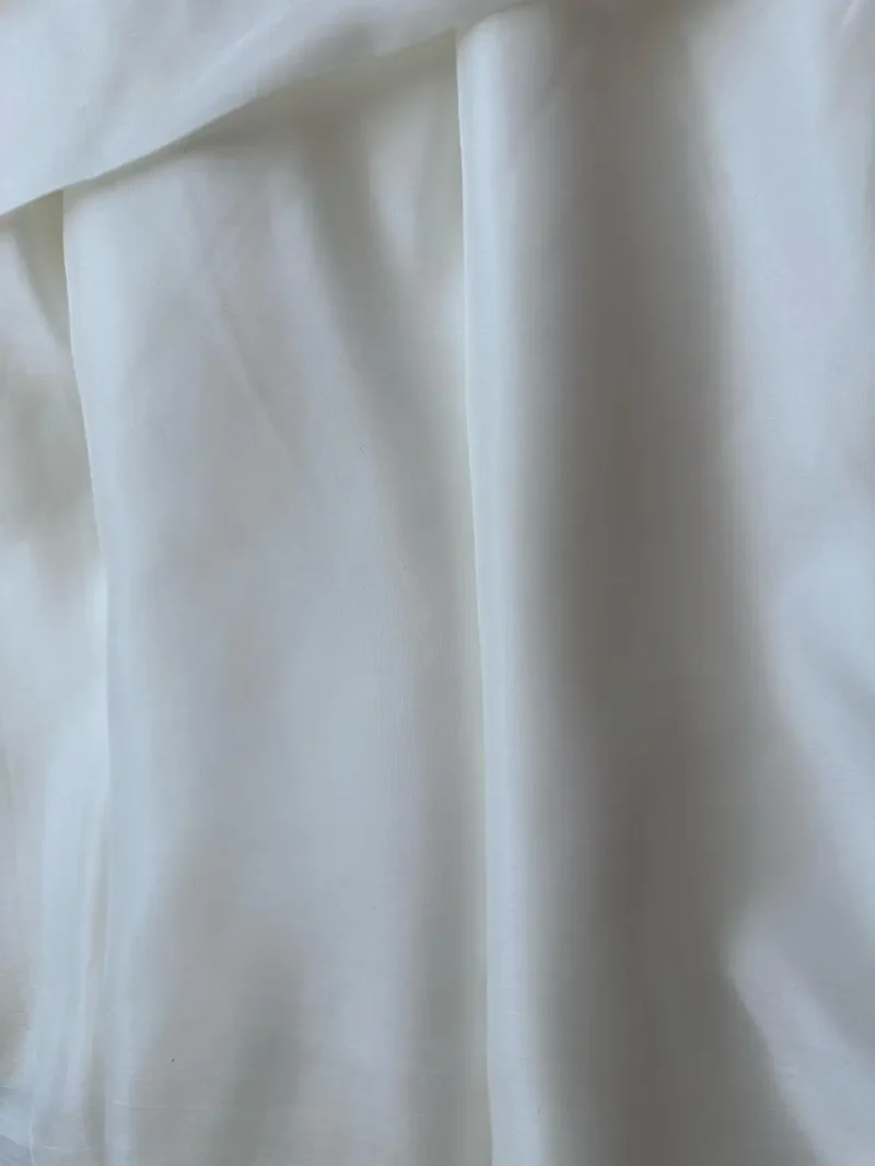 Draped off-white Mulberry Silk Satin with fluid movement, perfect for elegant skirts, dresses, or shirts
