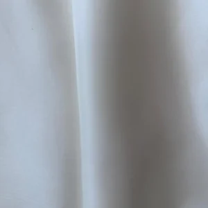 Close-up of off Silk Fabric White Italian Mulberry Silk Satin fabric with smooth texture and glossy finish, ideal for shirts and skirts